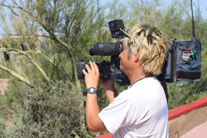 A filmmaker shooting footage from the entrance patio