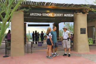 A docent greets guests at the museum entrance