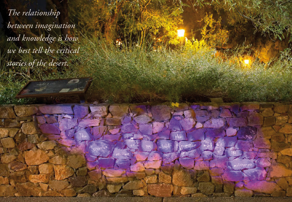 The relationship between imagination and knowledge is how we best tell the critical stories of the desert. [Photo of rock wall with scorpion poem illuminated by blacklight]